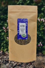 Brown paper bag with a label for pepper mint tea against a natural background