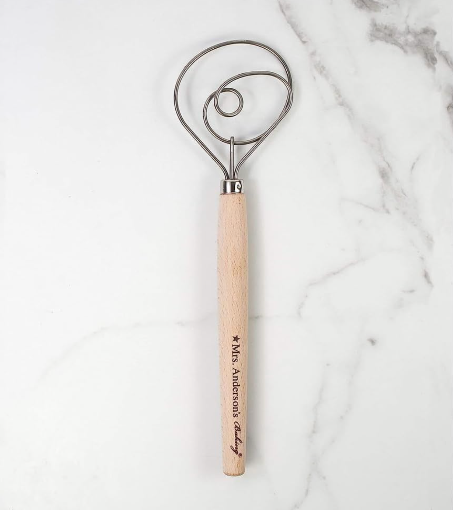 Kitchen tool with wooden handle and metal head made by Mrs. Anderson's Baking on a marble background